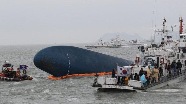 South Korean Coast Guard personnel search for missing passengers aboard the sunken South Korean ferry Sewol in the water off the southern coast near Jindo, South Korea on April 17, 2014.