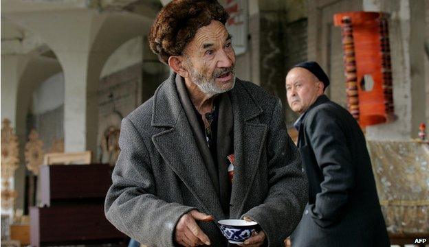 An older man holding a cup of tea in Tashkent