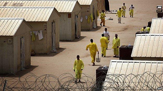 Iraqi detainees walk inside the Camp Bucca detention centre located