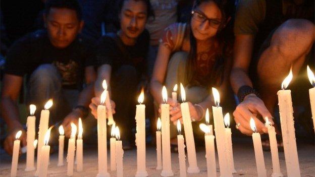 Nepalese people light candles in memory of the 16 Nepalese Sherpa guides killed in an avalanche on Mount Everest on 30 April 2014