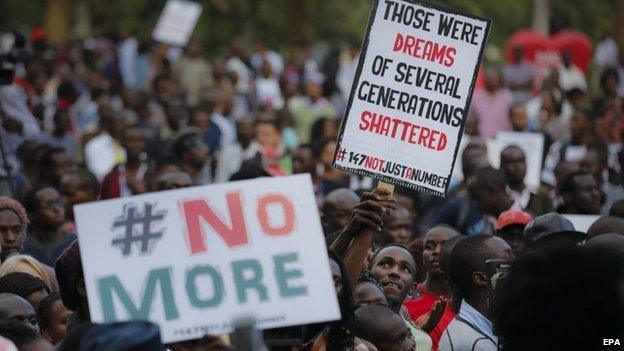 People listen as an artist gives a speech on the stage during a memorial concert held for the victims of an attack on Garissa University College that killed more than 150 people, in downtown Nairobi, Kenya, 14 April 2015.