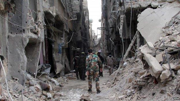 Palestinian fighters are seen walking at Palestine Camp near Damascus, Syria on 16 April, 2015.