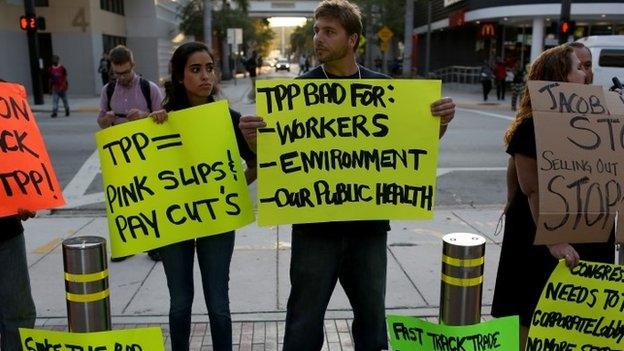 Union members and community activists protest outside the Miami Dade College where the Greater Miami Chamber of Commerce and the college were hosting a moderated conversation with U.S. Secretary of the Treasury Jacob Lew on March 20, 2015 in Miami, Florida.