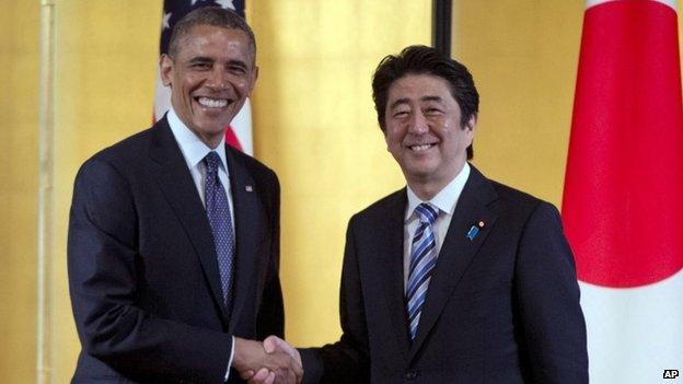 In this April 24, 2014 file photo, US President Barack Obama, left, and Japanese Prime Minister Shinzo Abe shake hands as they arrive to participate in a bilateral meeting at the Akasaka State Guest House in Tokyo