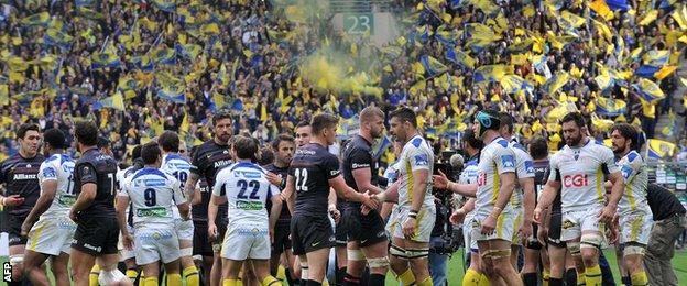 Saracens and Clermont players shake hands after the match