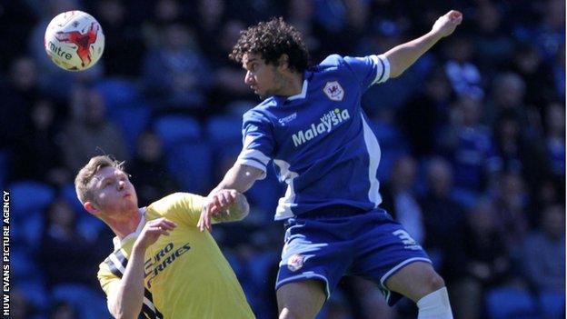 Fabio of Cardiff City challenges Aiden O'Brien of Millwall