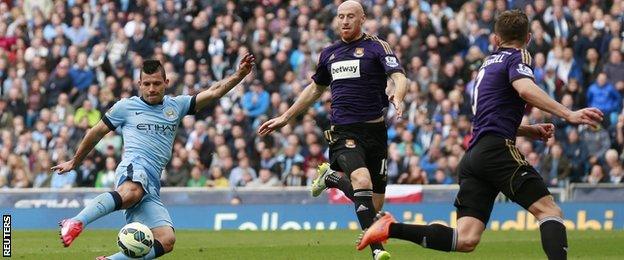 Manchester City striker Sergio Aguero (left) scores his side's second goal in the win over West Ham