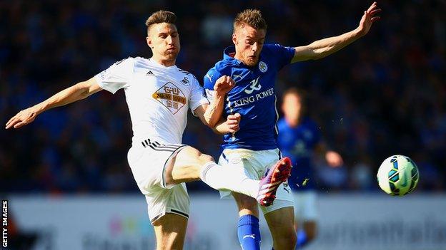 Angel Rangel of Swansea City and Jamie Vardy of Leicester City compete for the ball