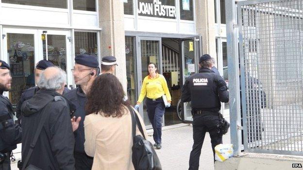 Spanish policemen are deployed outside the high school Instituto Joan Fuster after a student burst into the school with a knife and a crossbow in Barcelona, northeastern Spain, 20 April 2015