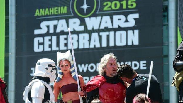 Fans dressed in costumes attend on the opening day of the 25th Star Wars Convention on 16 April, 2015 in Anaheim, California