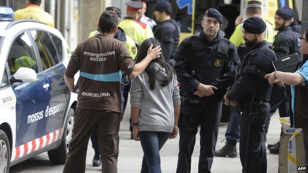 Emergency service members attend students at the Joan Fuste Fuster in Barcelona on April 20, 2015