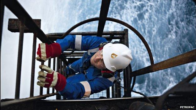 Petrofac employee climbing ladder