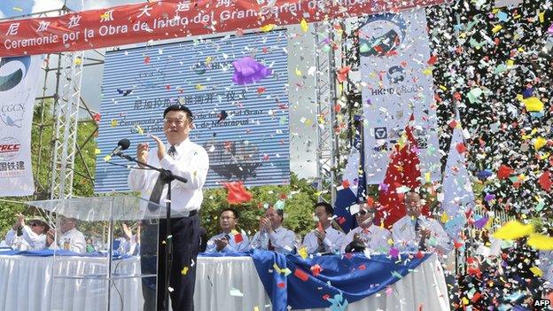 Chinese businessman Wang Jing of HKND Group applauds next to members of the Nicaraguan government during the inauguration of the works of an inter-oceanic canal in Tola, some 3 km from Rivas, Nicaragua, on December 22, 2014