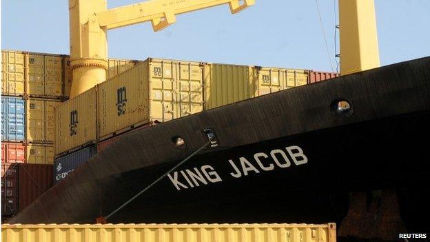 In this photo taken at the Palermo harbor on April 15 and made available Sunday, April 19, a view of the King Jacob Portuguese cargo vassel, the first ship to arrive near a boat believed to be crowded with 700 migrant in distress