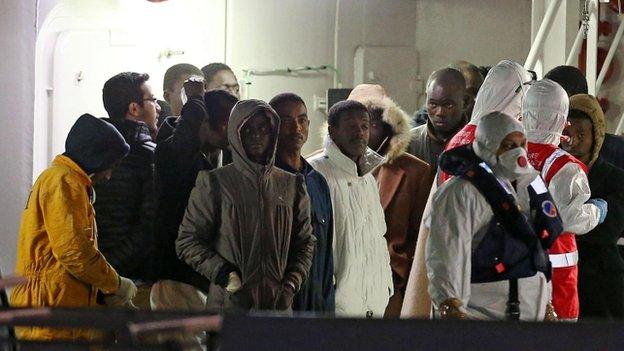 Survivors aboard Italian coastguard ship arrive at Catania, Italy, early Tuesday 21 April 2015