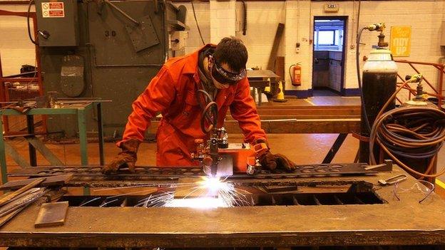 Man in boiler suit welding