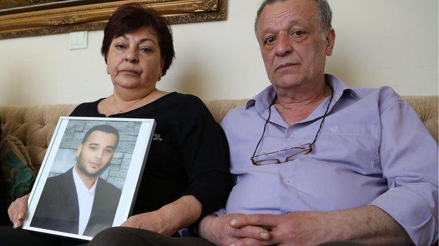 Sevag Balikci's family hold a photo of him