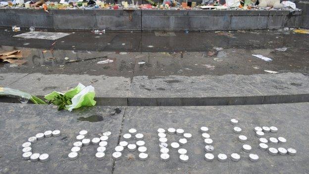 Charlie written in candles tributes to Charlie Hebdo victims at the monument on Place de la Republique, Paris