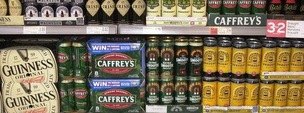 cans of beer for sale in a supermarket