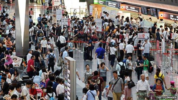 Travellers at Tokyo's Haneda airport