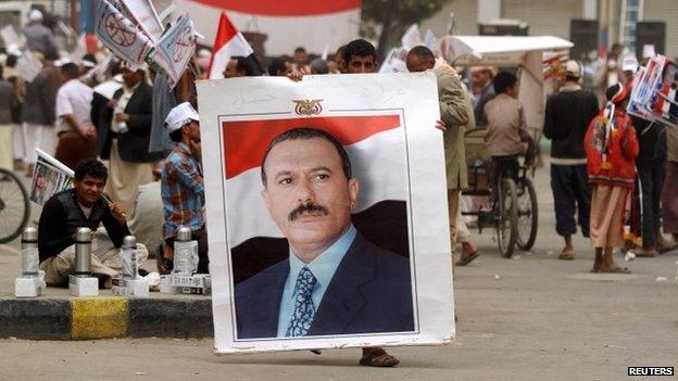 A man carries a poster of former Yemeni President Ali Abdullah Saleh at a protest in Sanaa, 3 April 2015