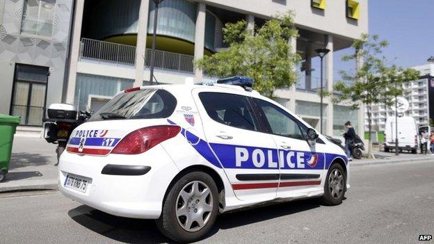 A police vehicle is parked outside the student residence where an It student, suspected of planning a church attack in France, lived in Paris on April 22, 2015