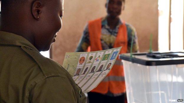 Woman takes part in early voting on 22 April by law-enforcement personnel in Togo's presidential election.