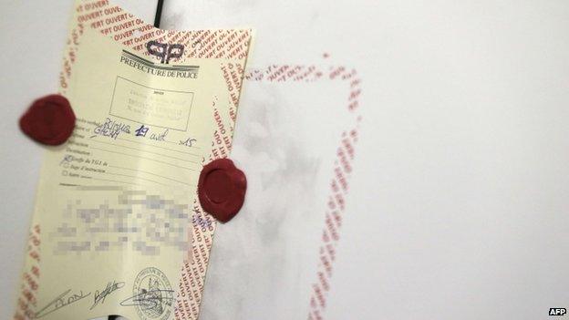 A picture taken on April 22, 2015 shows a police seal on the door of the room where lived Sid Ahmed Ghlam, an It student suspected of planning a church attack in France, at a student residence in Paris