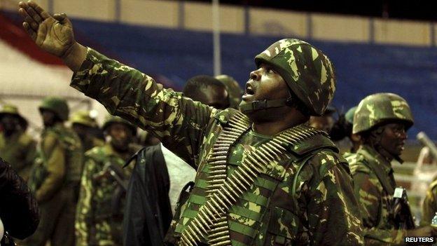 A policeman controls issued orders to his juniors when people rescued from the Garissa University attack meet their relatives at Nyayo stadium in Kenya's capital Nairobi 4 April 2015