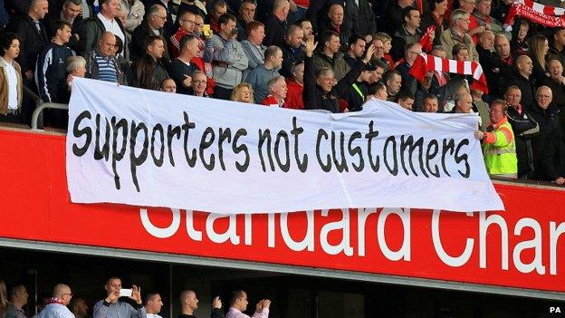 Supporters hold up banner