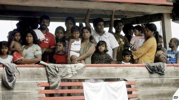 In this October 14, 2009, file photo, Sri Lankan migrants bound for Australia remain on board their boat docked at a port in Cilegon, Banten province, Indonesia, after they were intercepted by the Indonesian navy