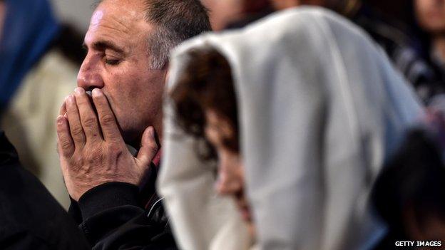 A man prays during a religious service at the cathedral in Etchmiadzin, outside Yerevan, on 23 April 2015