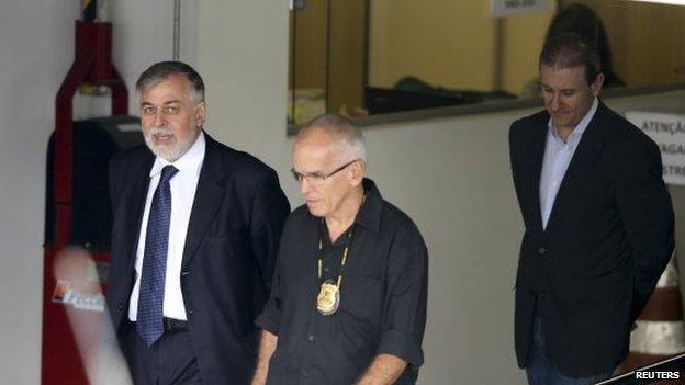 Former supply director of Petrobras Paulo Roberto Costa (left) and businessman and money changer Alberto Youssef (R) are escorted by federal police at Federal Police headquarters in Curitiba February 13, 2015.