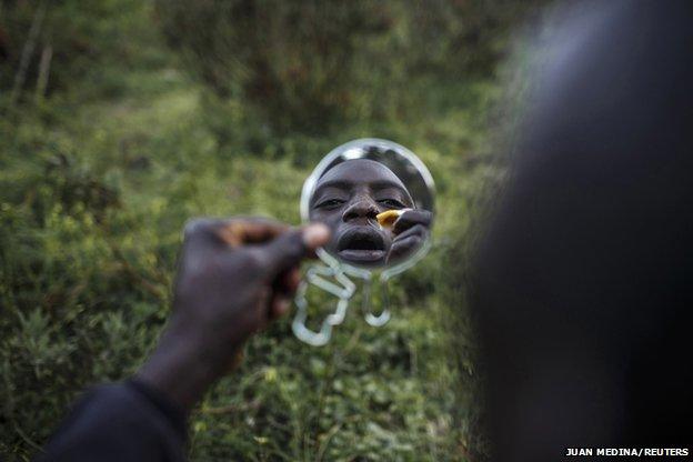 Mohamed from Togo heals wounds suffered while trying to swim from Morocco to Spain at his hiding place in the mountains near Spain's North African enclave of Ceuta, February 26, 2014