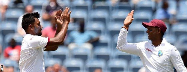 Devendra Bishoo (left) celebrates a wicket with Shiv Chanderpaul