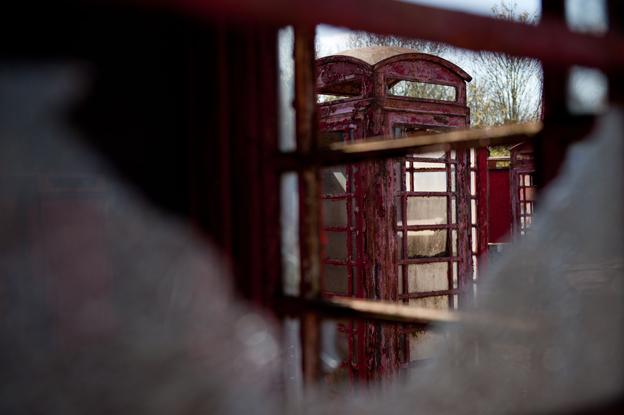 View through broken window of old phone box