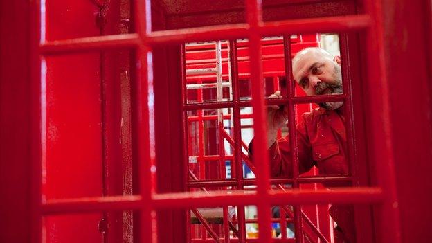 Man renovating phone box