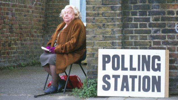 Woman sitting outside polling station