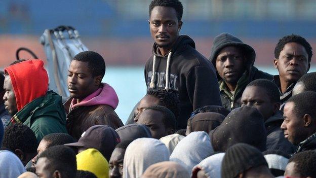 Rescued migrants disembark at the Sicilian harbour of Catania on 23 April 2015