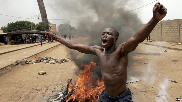 File picture shows a Togolese opposition protester brandishing a club in the unrest that followed the disputed 2005 presidential election