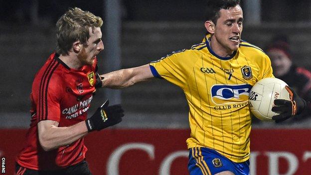 Down's Danny Savage is held off by Roscommon opponent Ciaran Cafferty