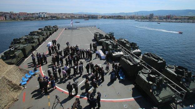 The Prince of Wales and Prince Harry attend a reception on HMS Bulwark