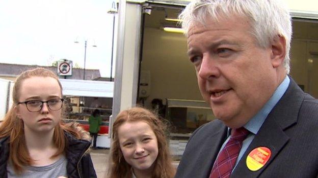 Carwyn Jones talking to pupils in Ammanford