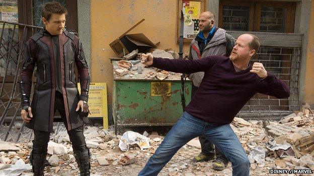 Joss Whedon on set with Jeremy Renner, as Hawkeye