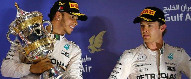 Lewis Hamilton celebrates his win at the Bahrain Grand Prix as Nico Rosberg looks on