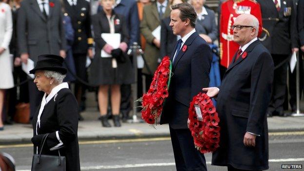 David Cameron and Australian Attorney-General George Brandis behind the Queen at the Cenotaph