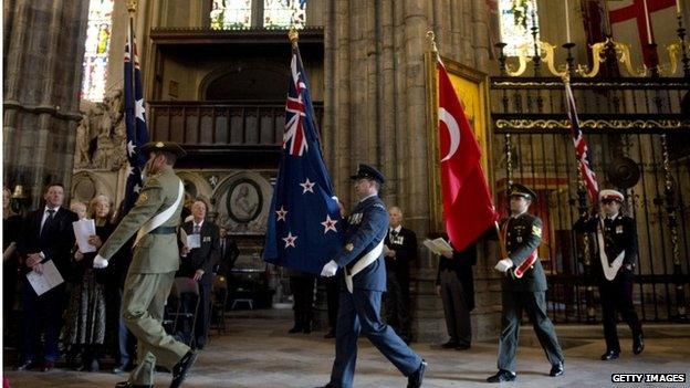 Flag bearers enter the Service of Commemoration at Westminster Abbey