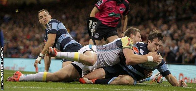 Garyn Smith of Cardiff Blues is pushed into touch just shy of the try line by Dan Biggar of Ospreys