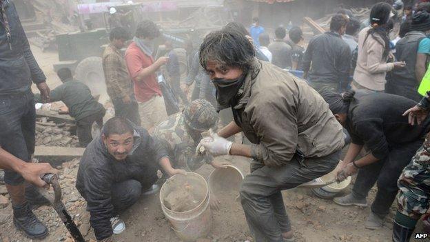 People clear rubble in Kathmandu's Durbar Square