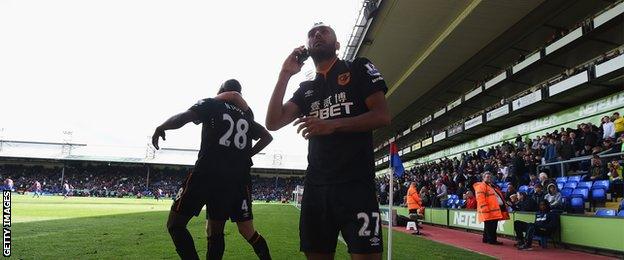 Hull City's Ahmed Elmohamady with a mobile phone after his side score against Crystal Palace